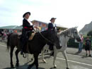 The two lead women on their horses 